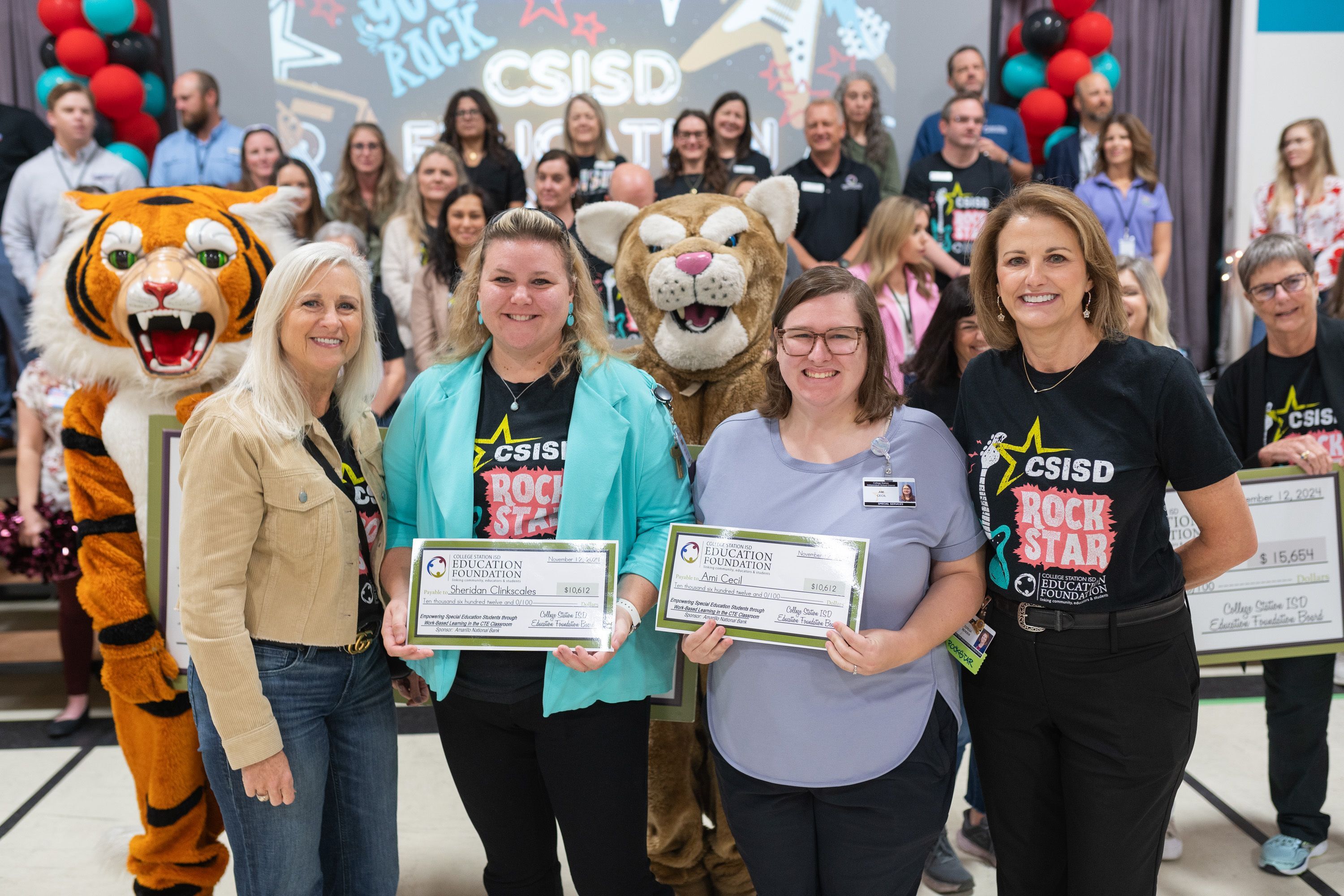 Teacher with checks from the Education Foundation