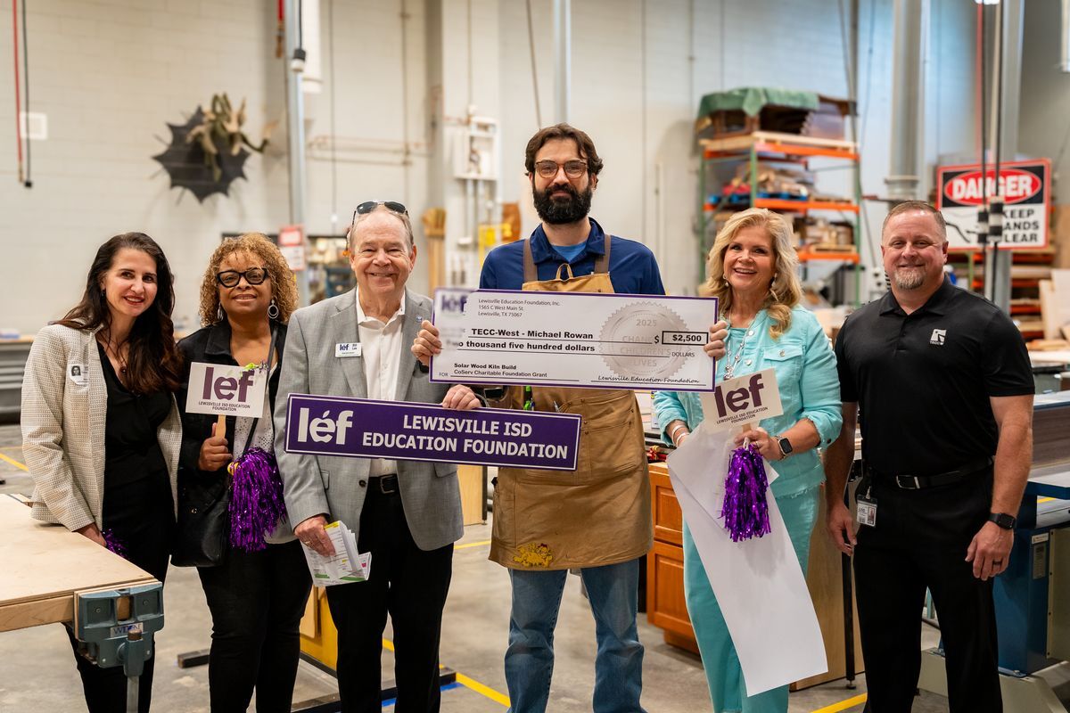 teacher and LEF volunteers with grant check in TECC West center
