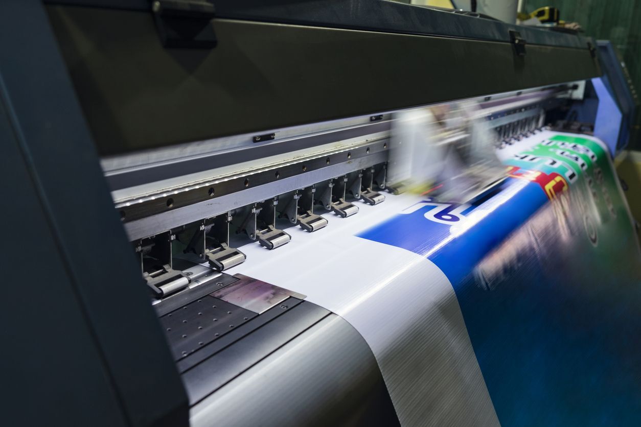 Large format printer producing a full-colour vinyl banner for custom business signage