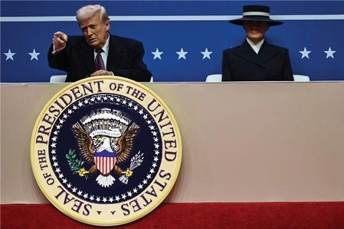 U.S. House of Representatives Office Plaque – A polished gold seal mounted on wood displaying the emblem of the House of Representatives, positioned in a congressional office setting.
