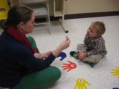 Toddler working with a teacher.