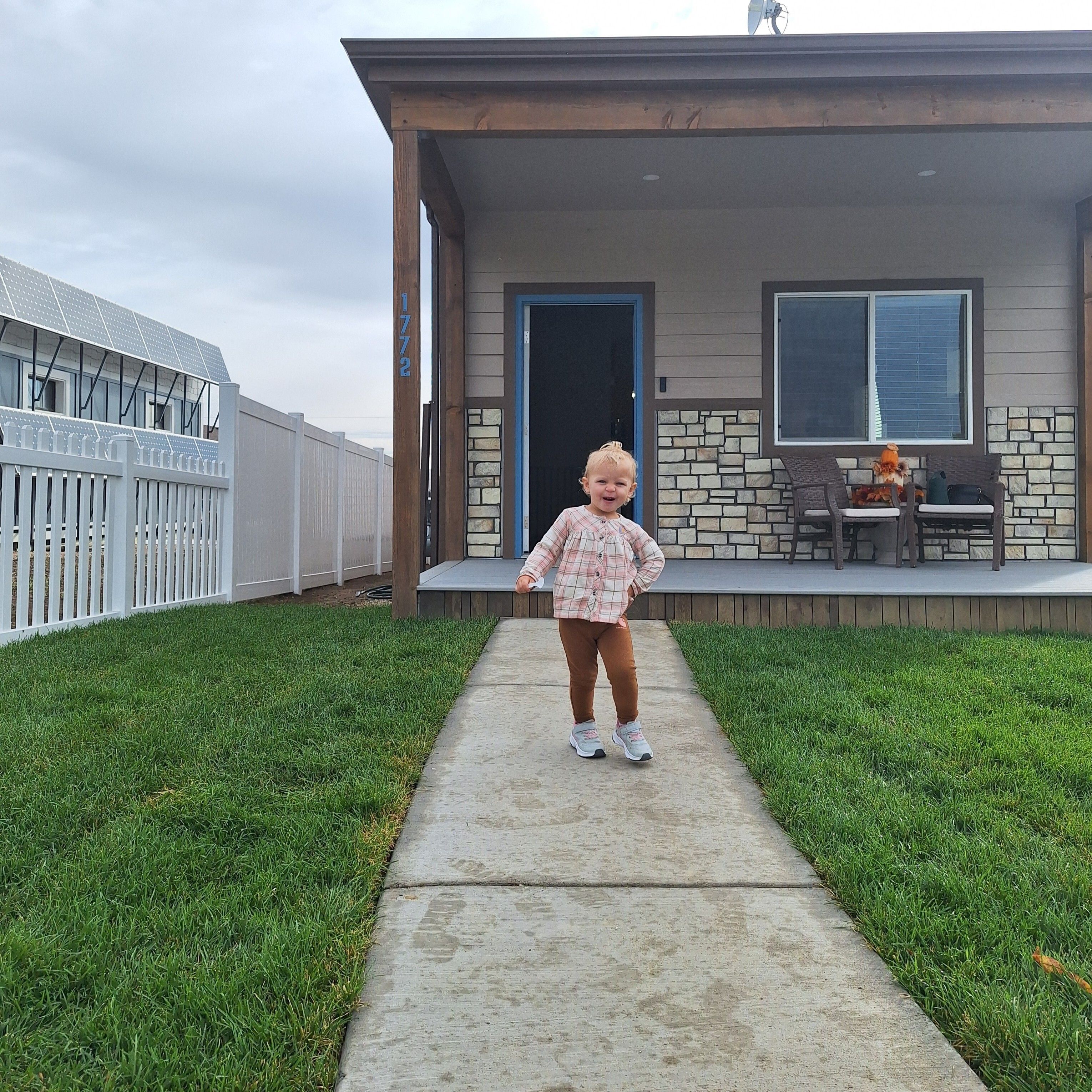 Addison's daughter running in her front yard.