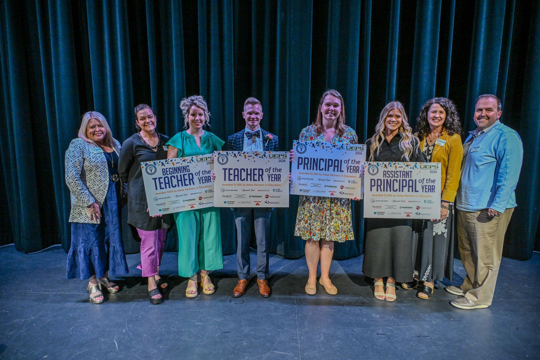 People holding a big check.
