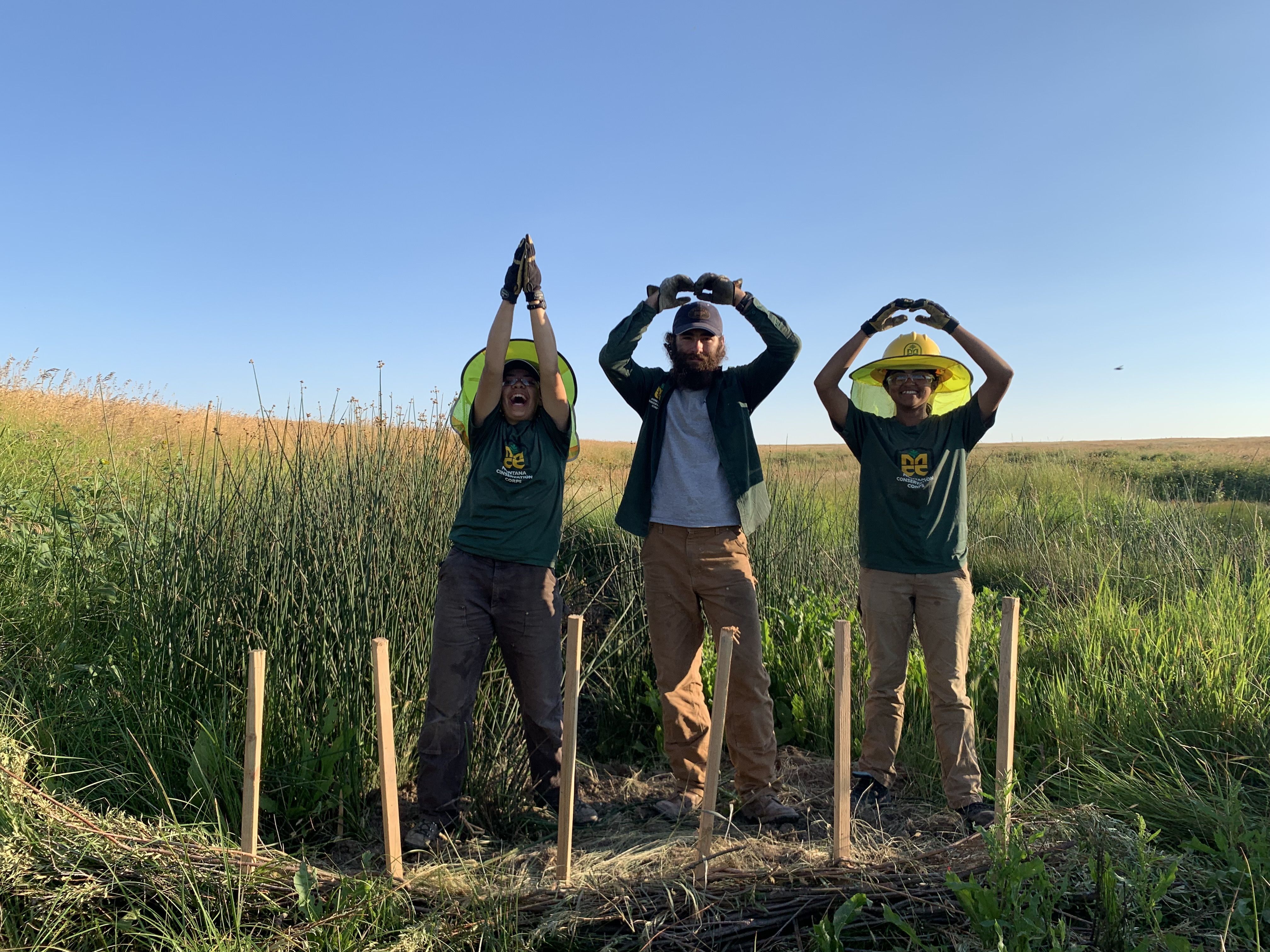 Crew members form "100" with their hands