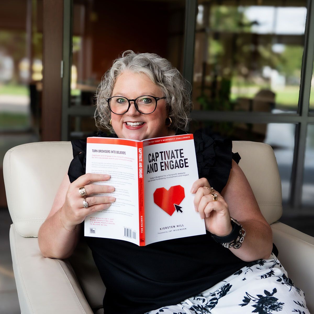 Author, Kiersten Hill, holding Captivate and Engage book.