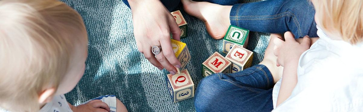 Adult playing blocks with children