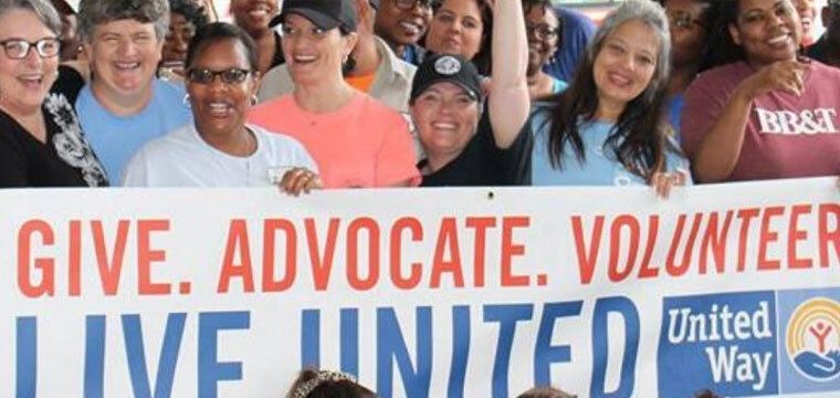 Group of people holding up United Way banner