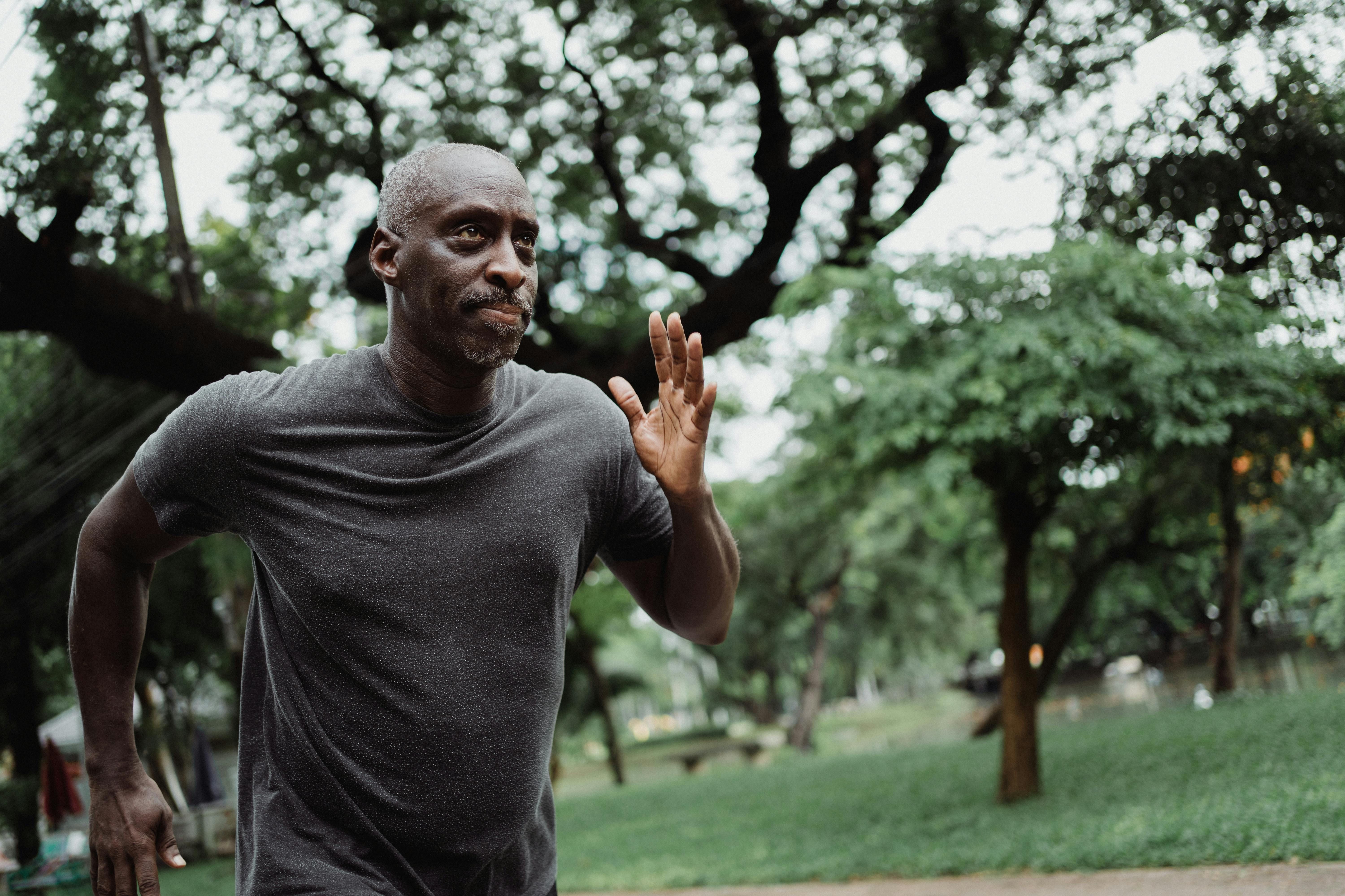 man running outside surrounded by trees