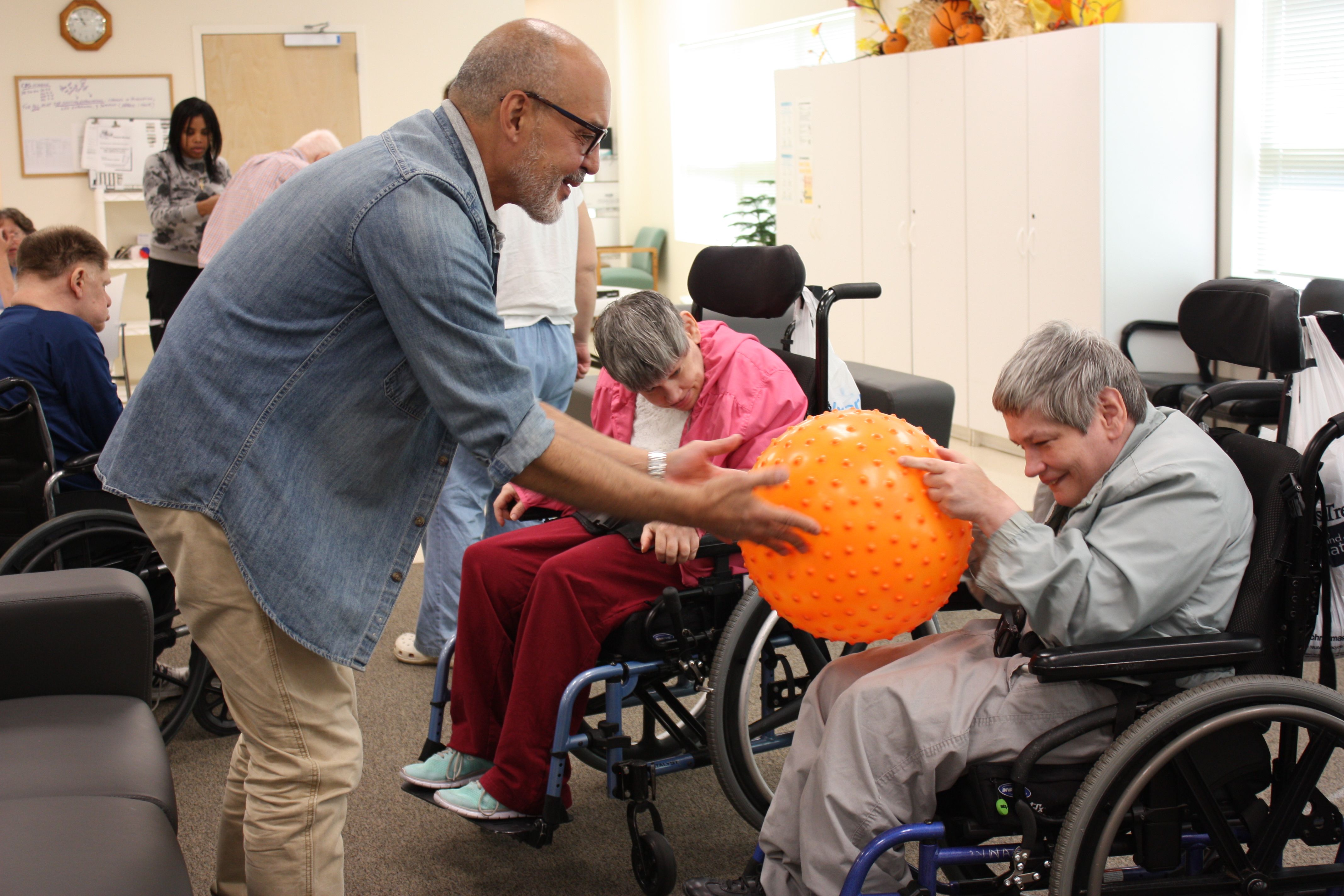 Manager, Mel Santiago provides sensory experience for a participant in the Shore Program.