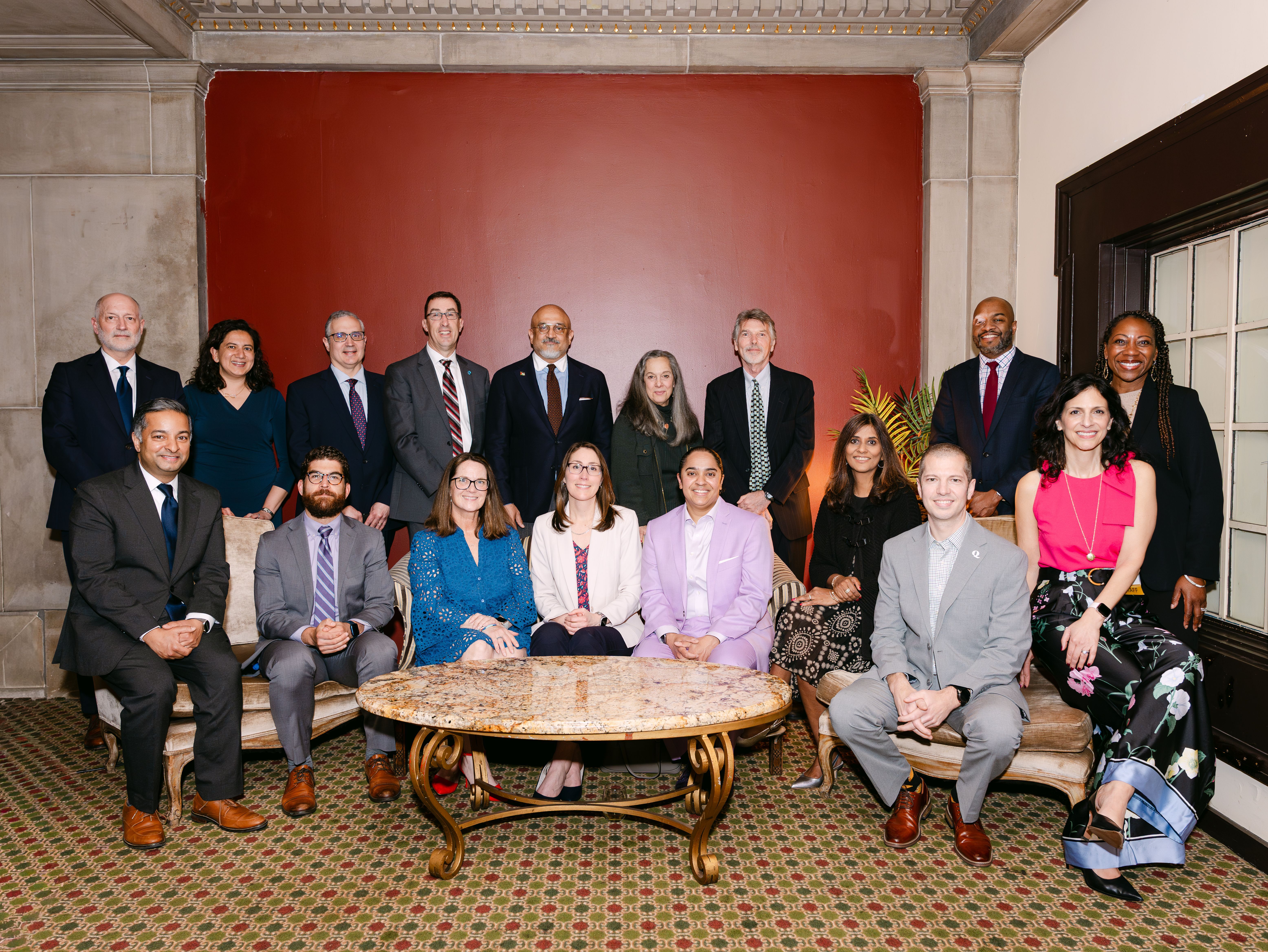 Formal image of 16 members of CBF's Board of Advisors. Members are outside with some sitting and some standing.