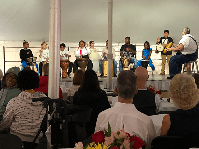 Student drummers entertain a packed house under the tent.