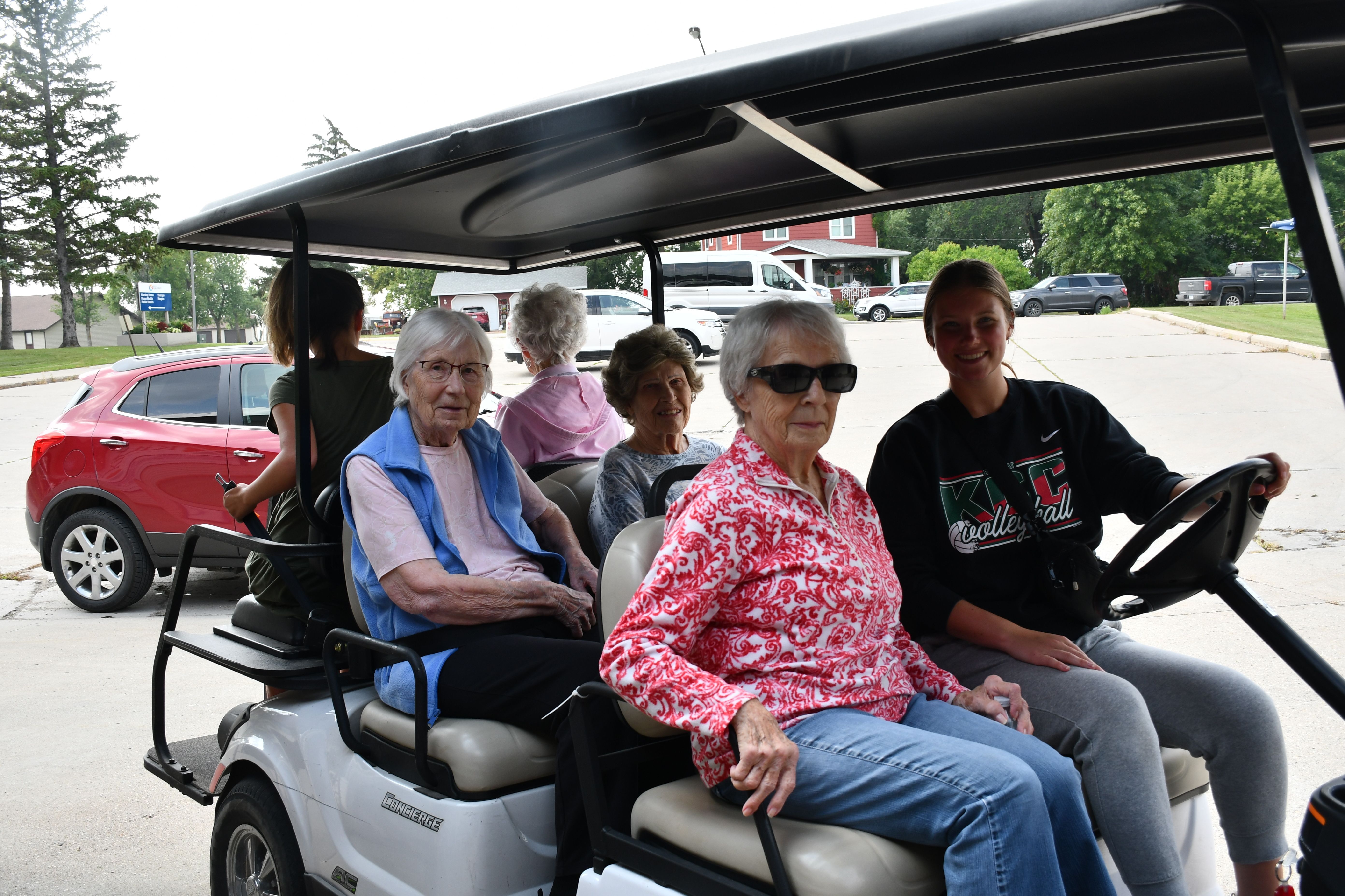 Residents go for a golf cart ride.