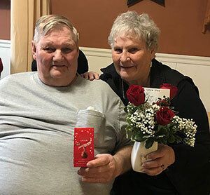 A couple with flowers.