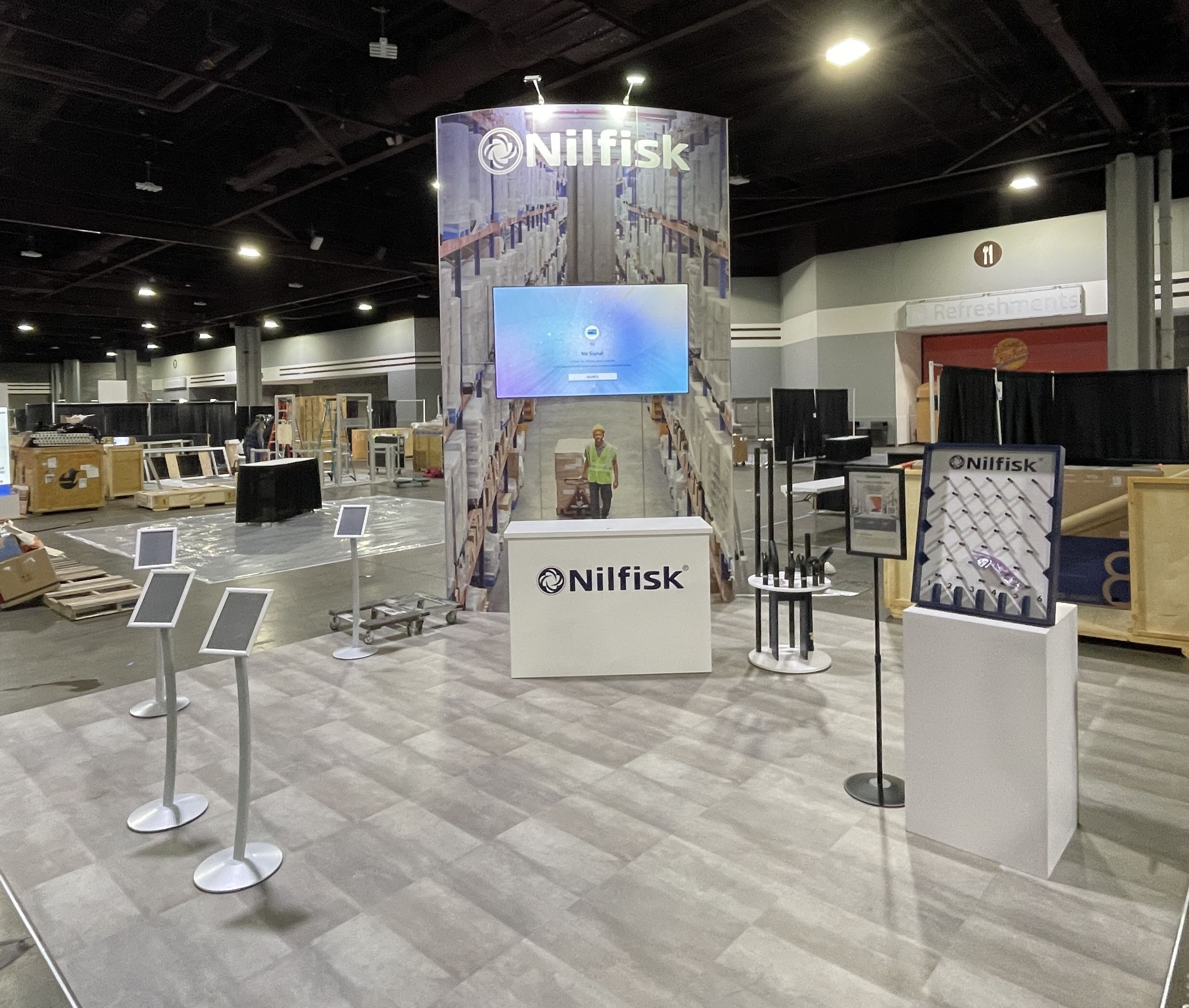 Tradeshow booth with oversized, printed wall panels and an lcd flat screen display