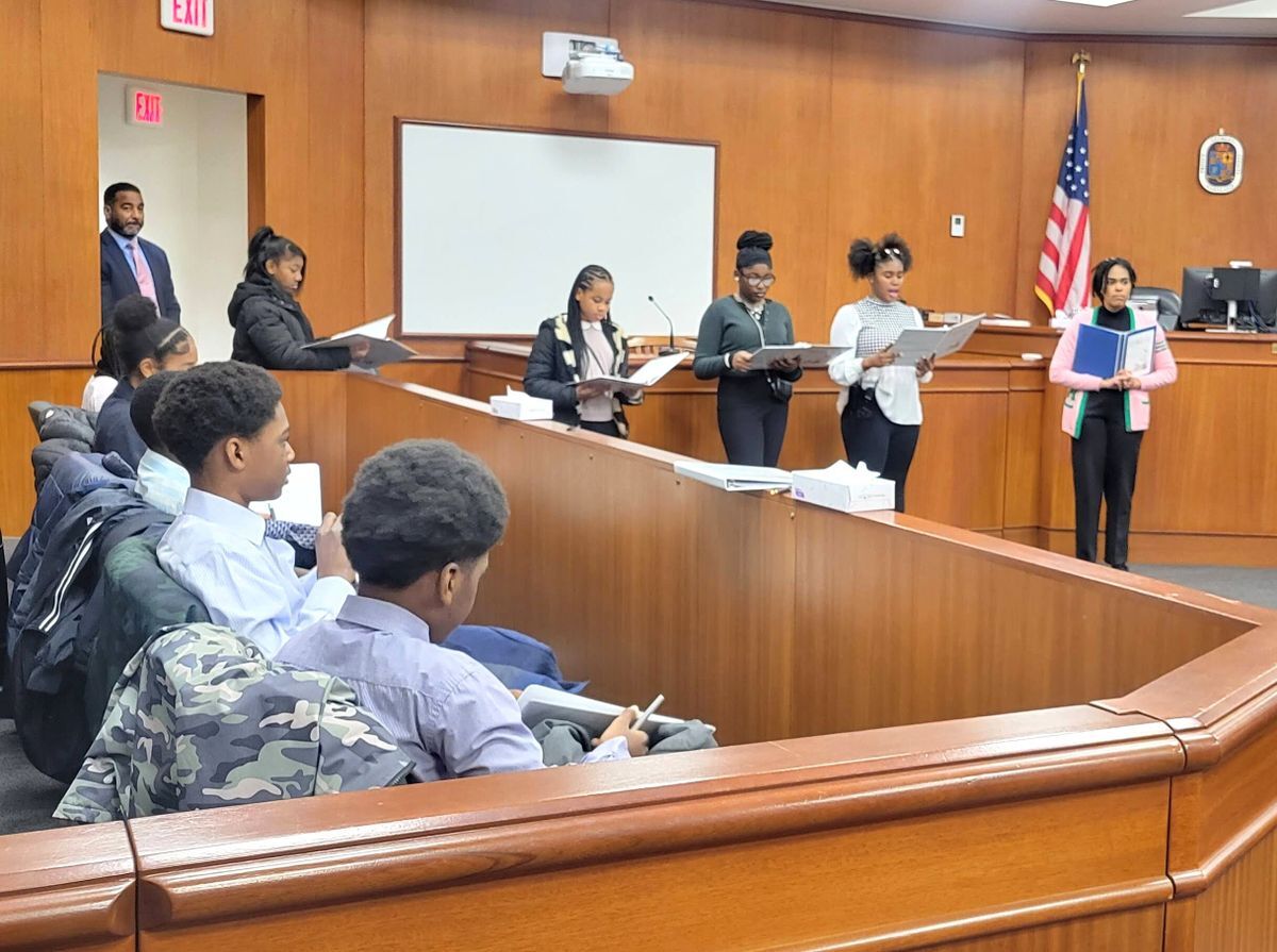 students mock trial in courtroom