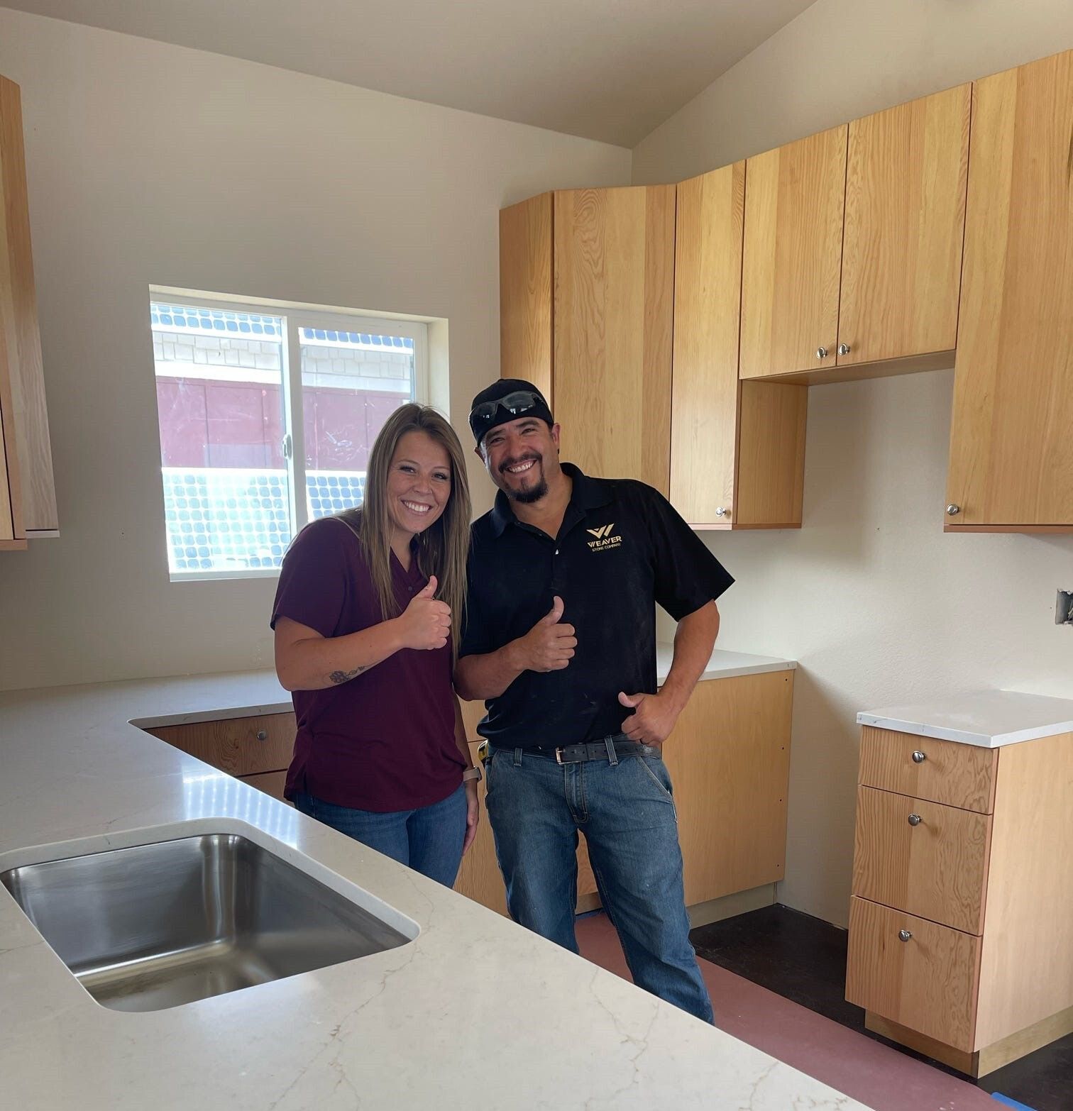 Addison with Weaver Stone Company, after she received a donation of countertops for her house.