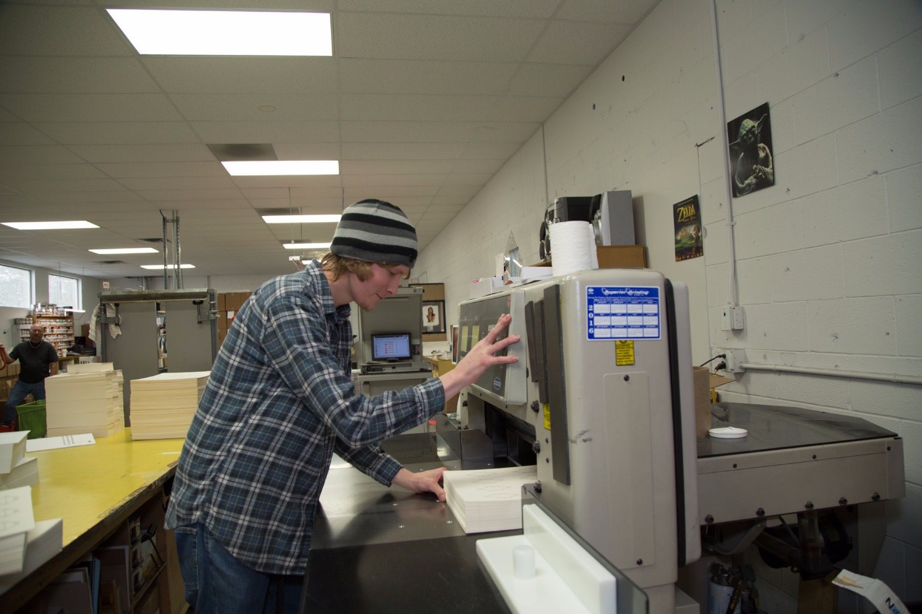 print shop worker applying finishing touches in salt lake city