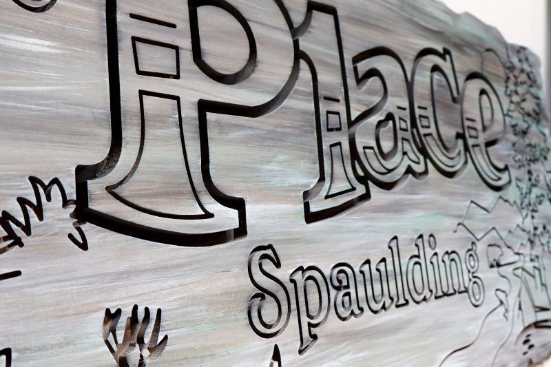 M22028A - Carved Sign for a Family Cabin with Raised Text and Artwork