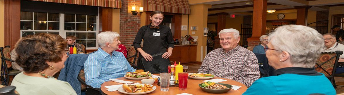 Server interacting with residents in the Bistro