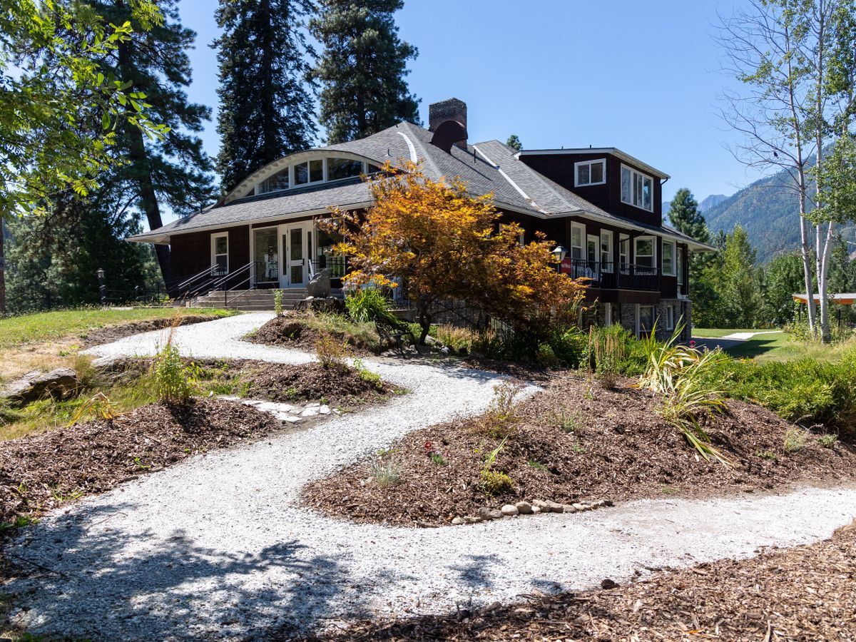 A brown building called the River Haus set in the background with a compact gravel accessible pathway leading to the entrance.