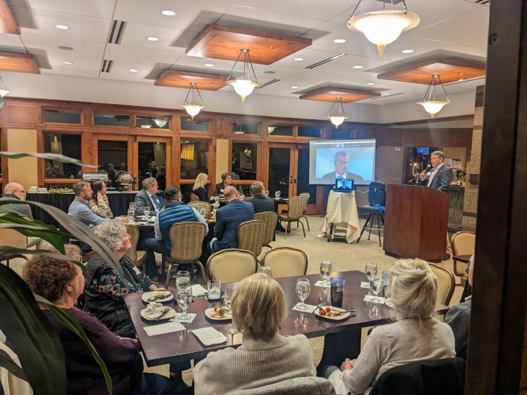 Justice Richard Gabriel speaks via Zoom to an audience gathered in Grand Junction, Colorado