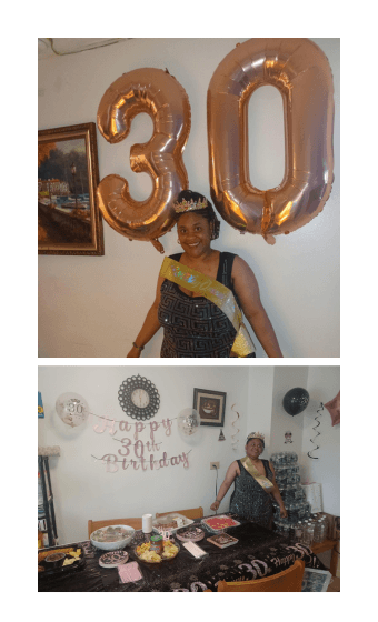 Photo of Dominique with large balloons and decorations and food