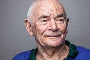 Elderly man smiling.