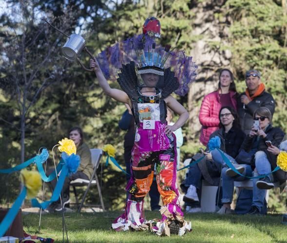 A photo of a woman walking down the runway in her elaborate outfit.