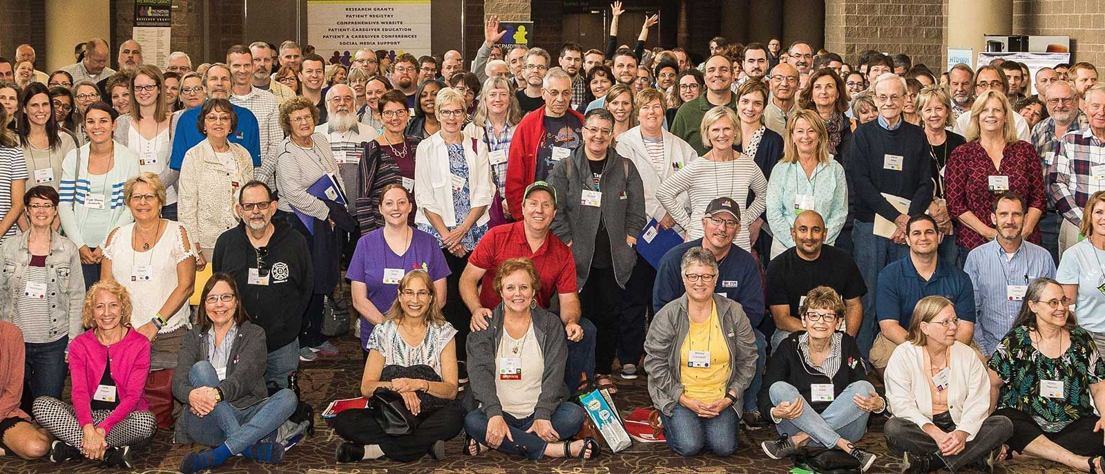 A large group of PSC Partners conference attendees pose for the camera, all smiling