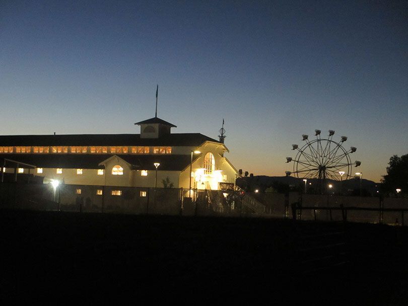 Evening shot of Missoula County Fair building and ferris wheel.