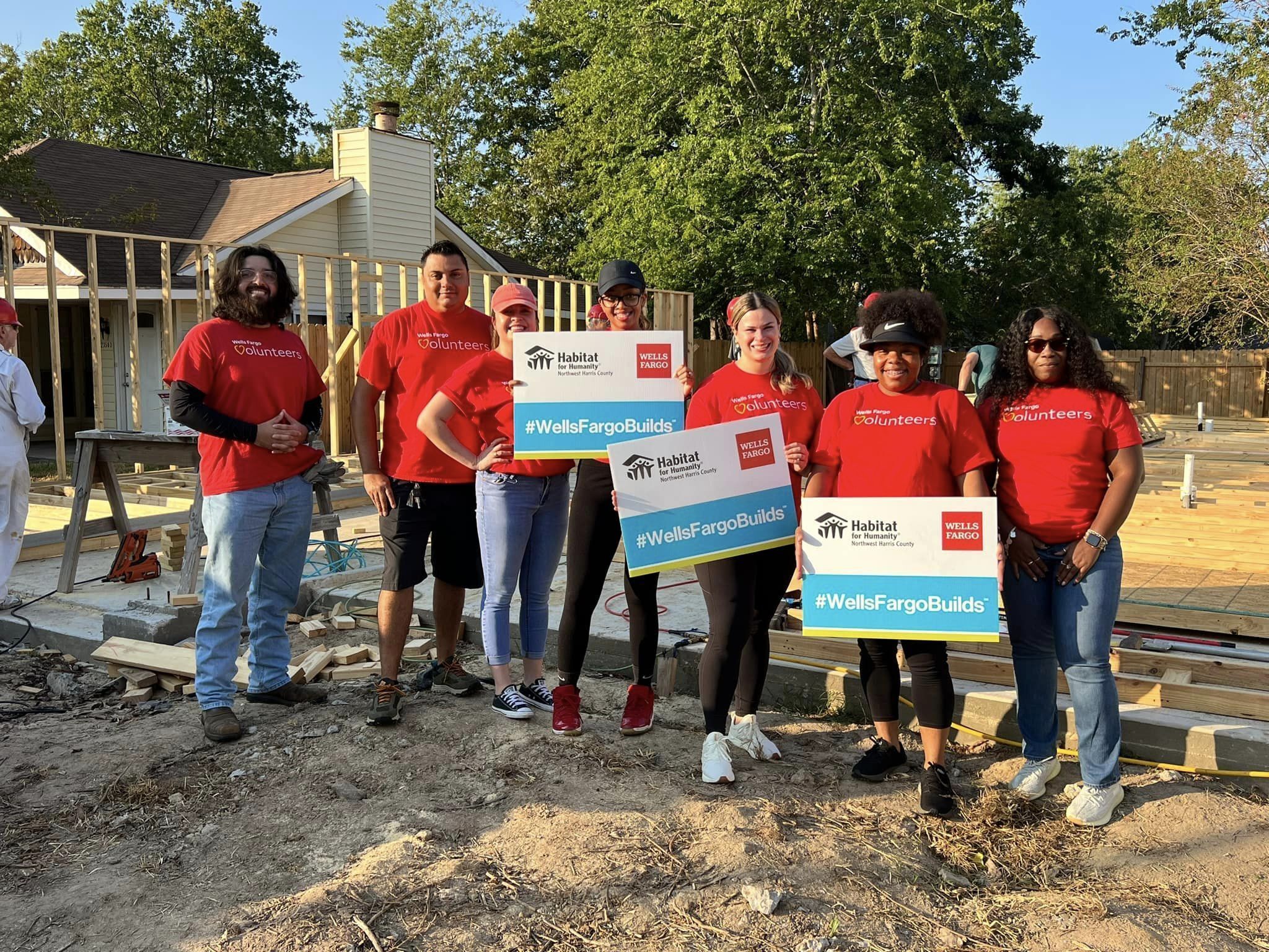 Wells Fargo employees pose for a picture at the build site.