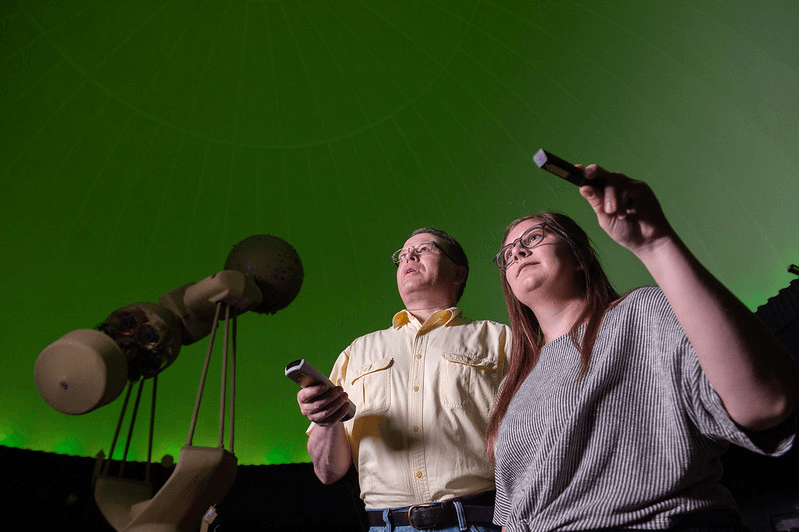 Wes Anderson and Syd Schmidt operating a show in the planetarium