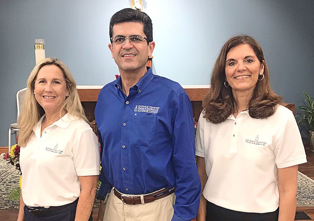 Frankie Chevere, CEO of Catholic Charities of the Diocese of Palm Beach, poses for a photo with Deanna Herbst-Hoosac, Catholic Charities ambassador from St. Ignatius of Loyola and Donna Pearson, director of parish social ministry at Catholic Charities.
