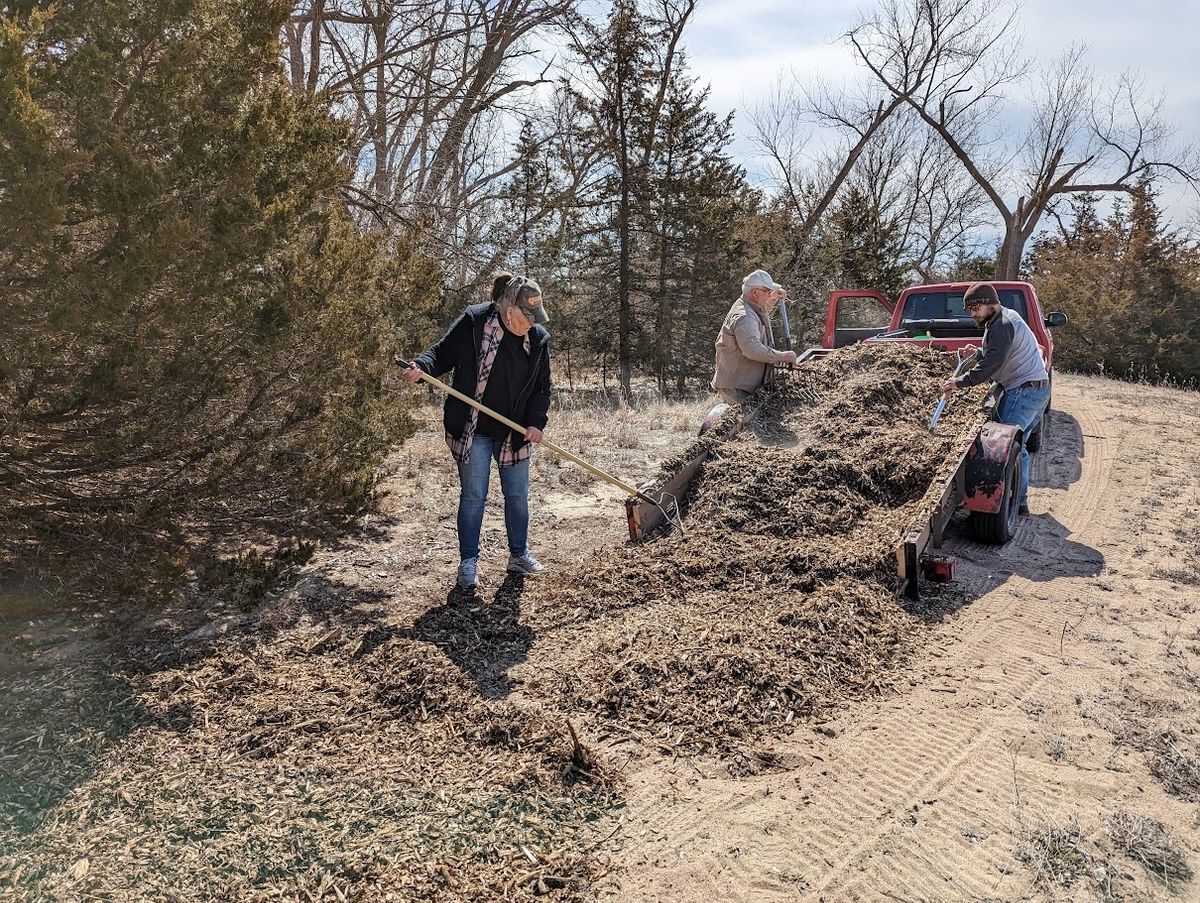 Volunteers helping add wood chips to the trails at Bader Park