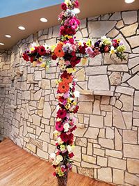 Photo of Easter Cross with flowers.