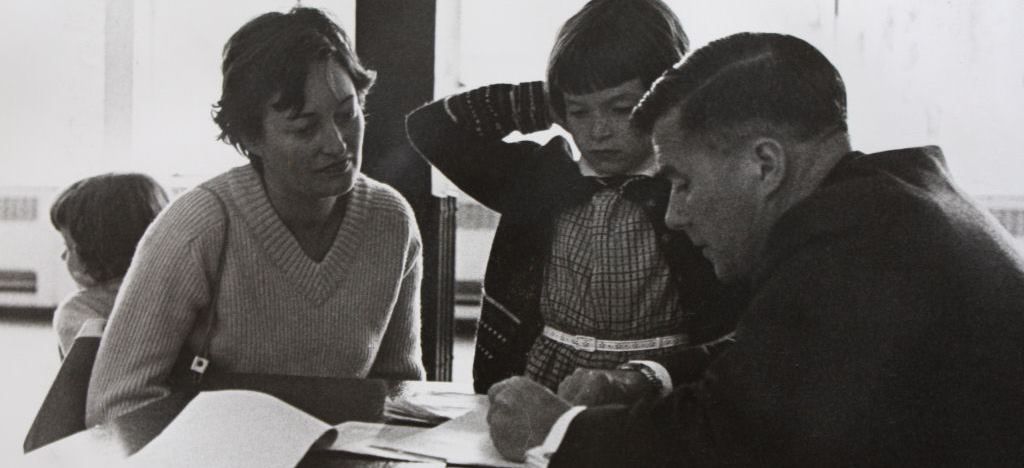 A parent and child meeting with an educator.