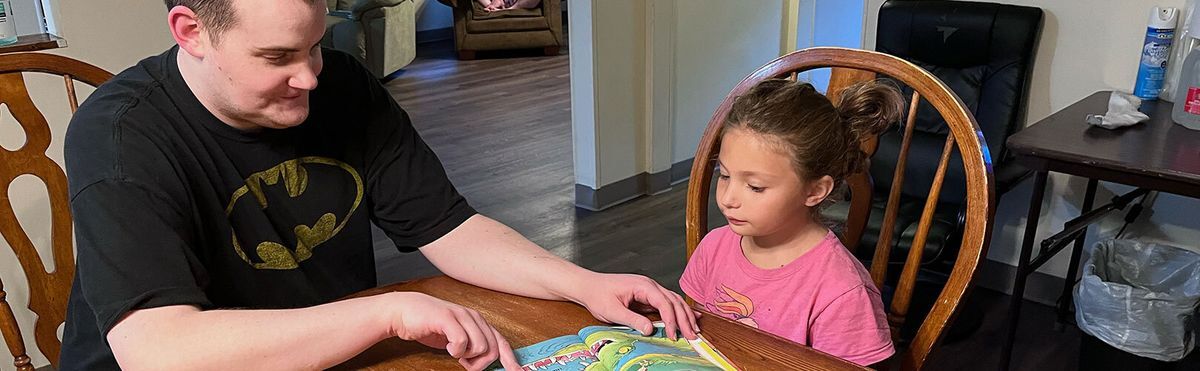 Man reading to a child.