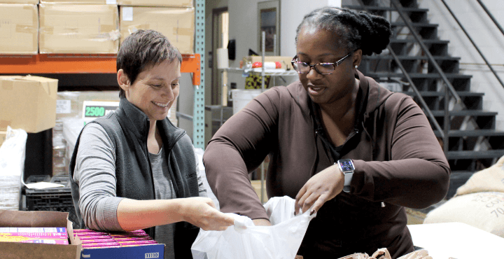 A Home for Families volunteer works with a case manager to help organize meal kits for Columbus area clients and families experiencing housing instability