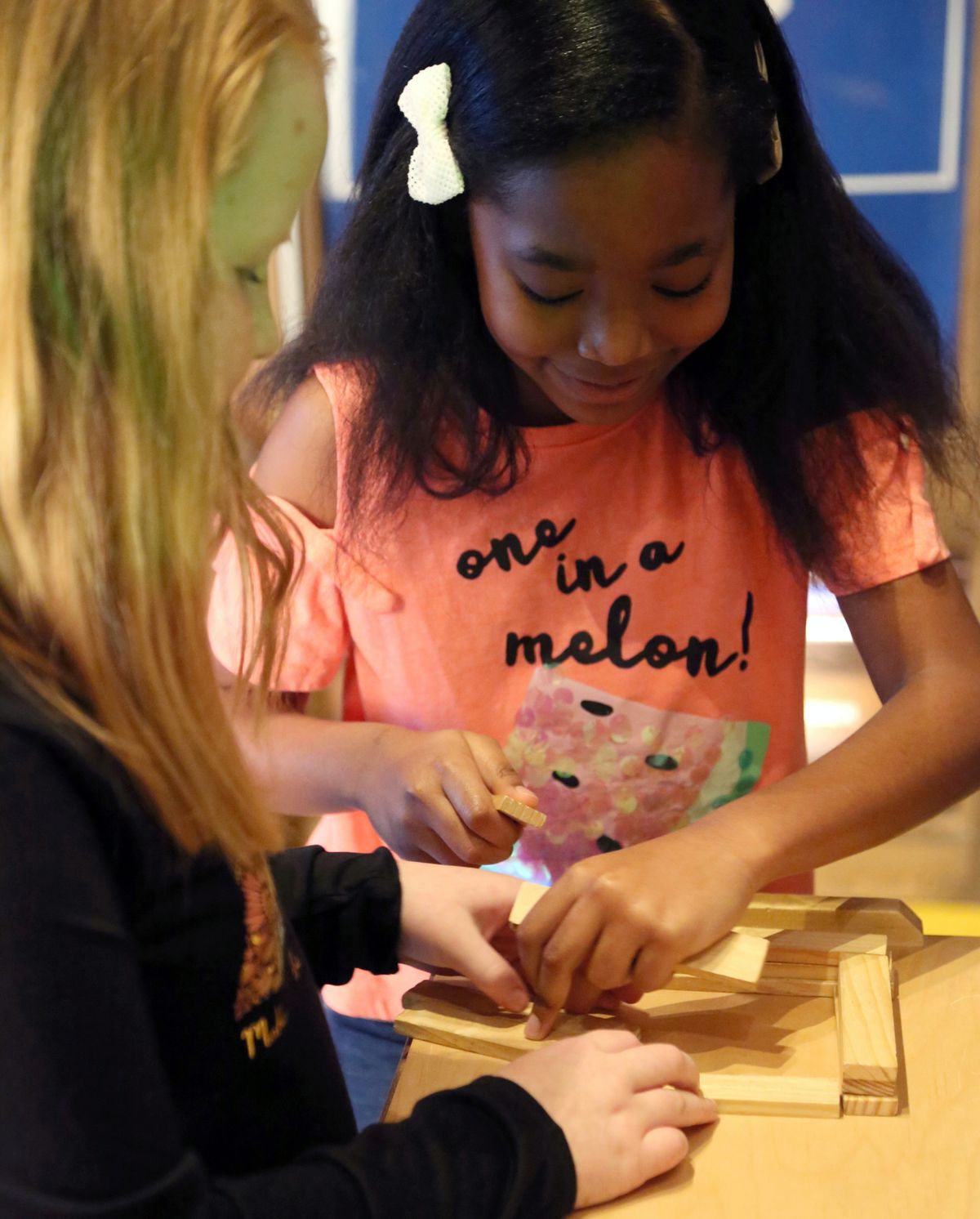 Two girls playing with building blocks in the Smoky Hill Museum exhibit The Curiosity Shop.