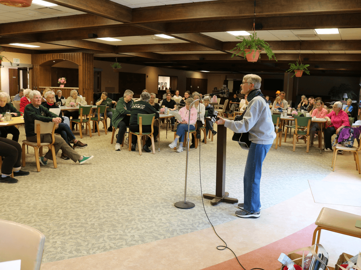 Oblate Co-Director Susan Jenczka leads sisters and guests in a sing along.