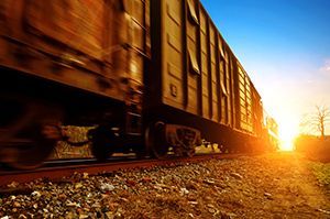 Train cars in motion toward the sun