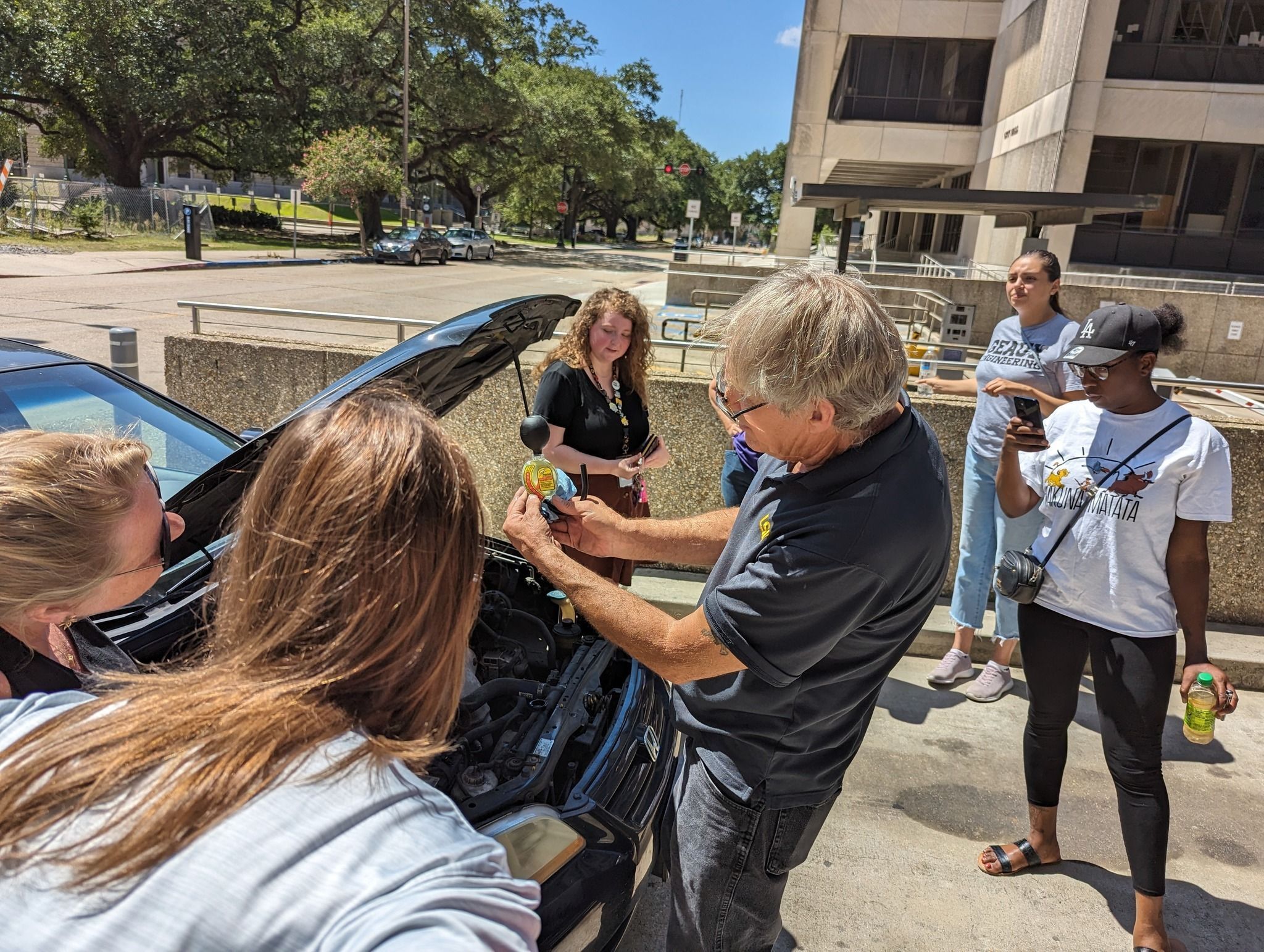  STEM librarian shows participants basic auto maintenance during the SPARK Your Summer series at the East Baton Rouge Parish Library.