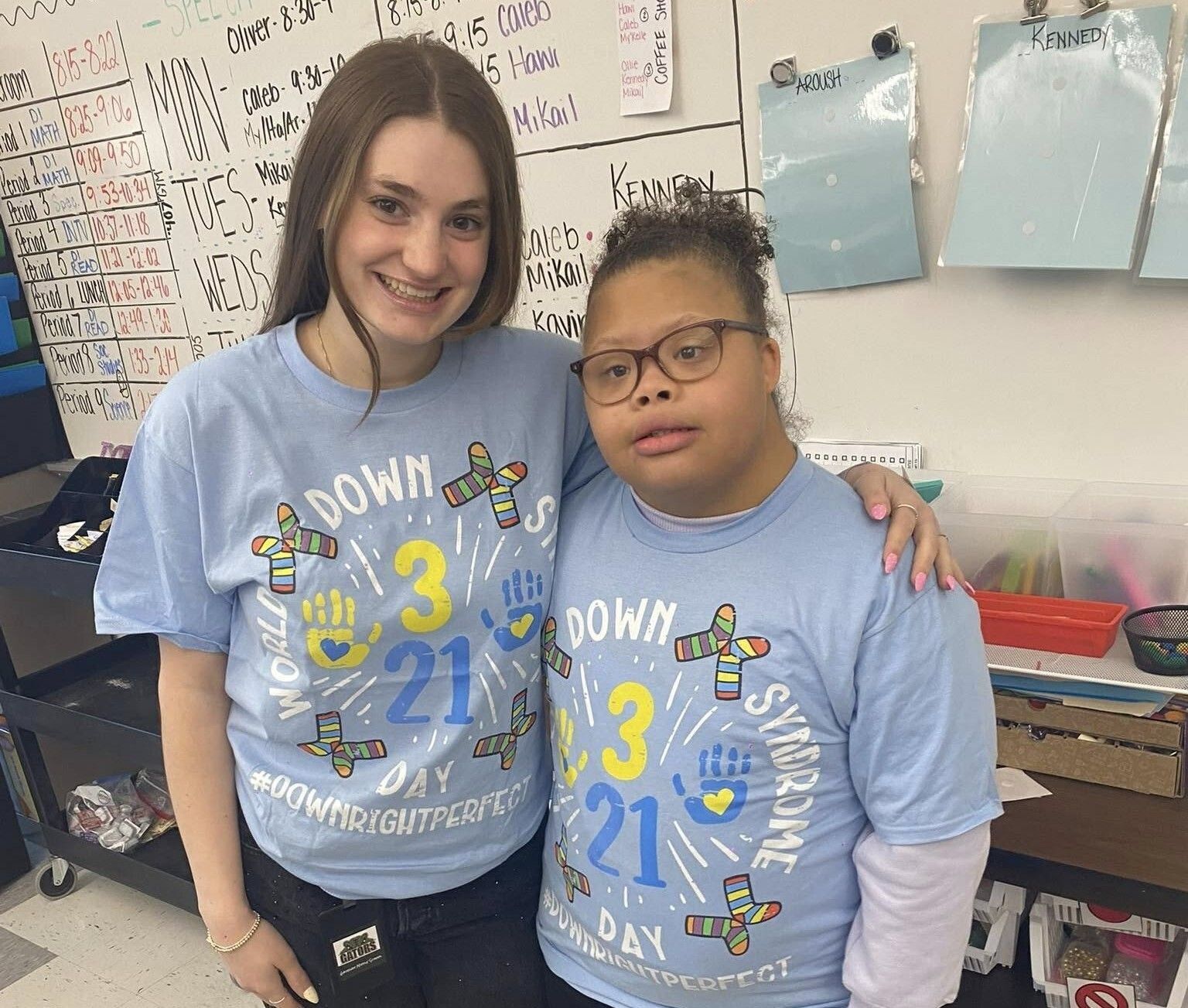 Girl holding her small dog.