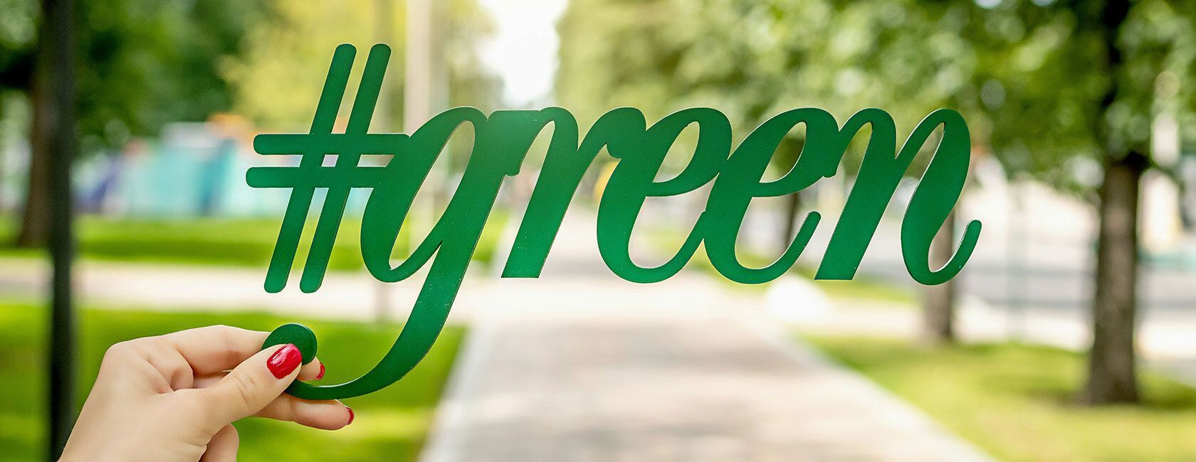 Hand holding a #green sign.