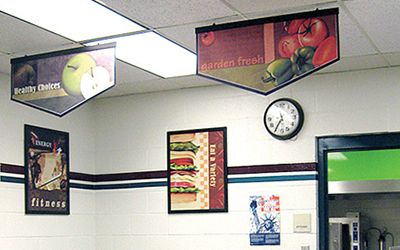 School lunch line with 2 banners and 2 food posters, custom signs, school banners