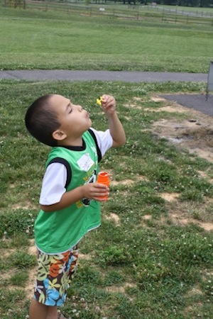 Cute boy blowing bubbles