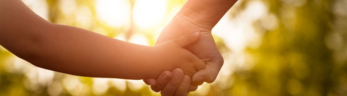 Parent holding a child's hand