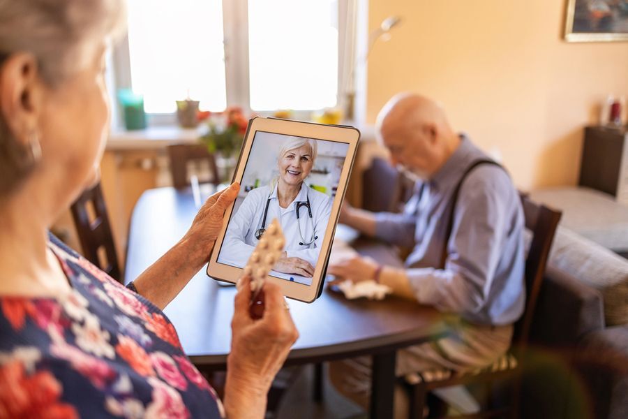 Older couple accessing telehealth appointment via tablet.