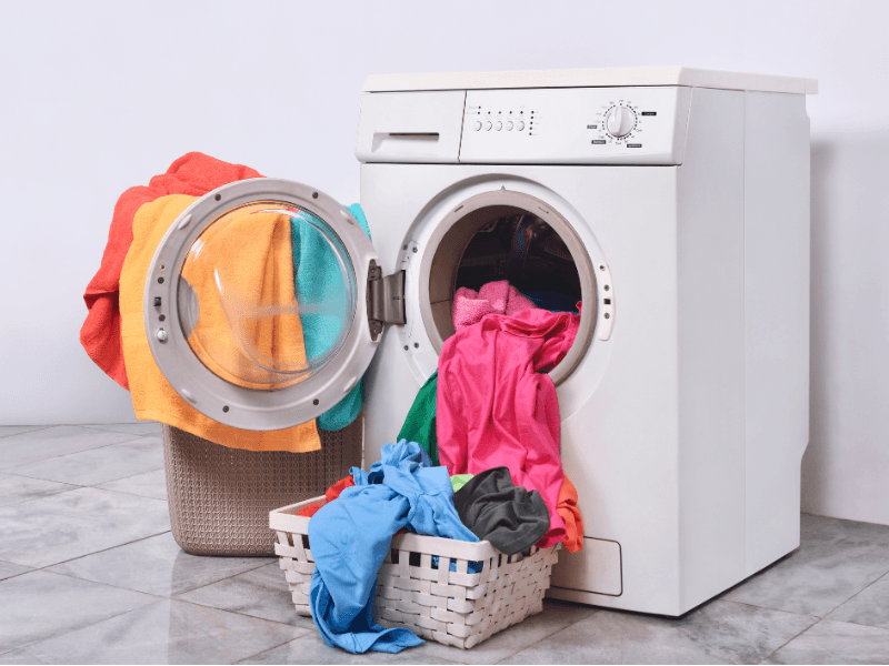 Laundry basket and washing machine at home.