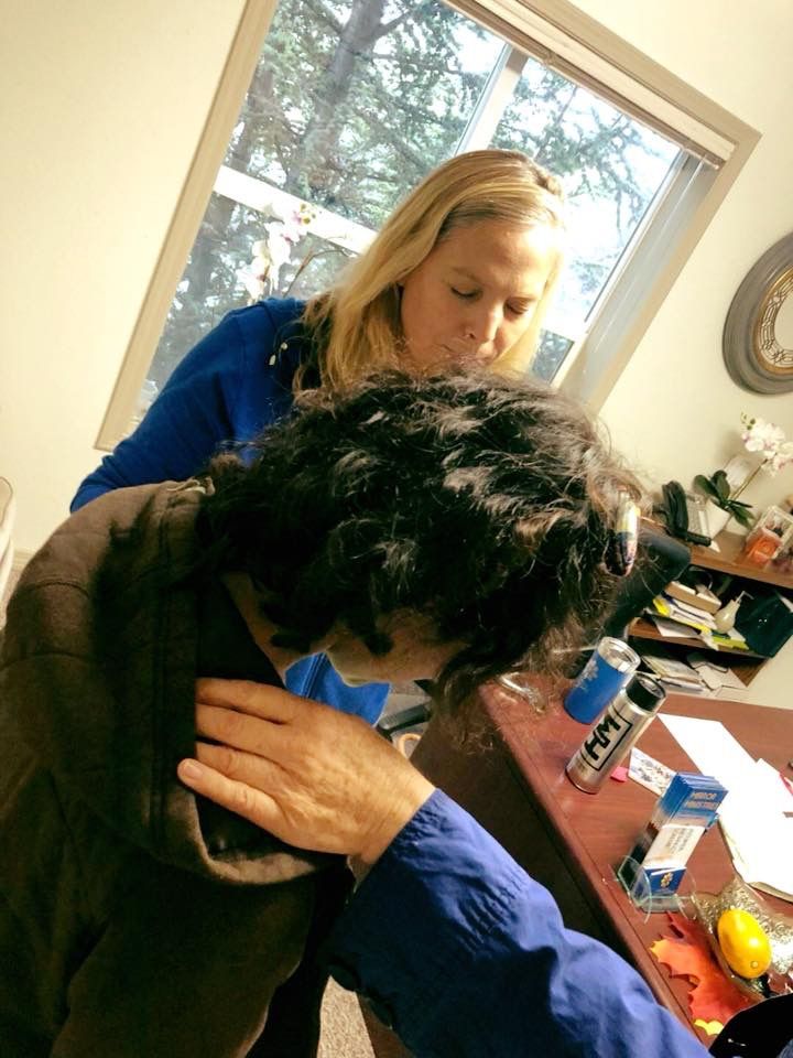 Praying over a client as she takes a big step along her healing journey and heads to rehab